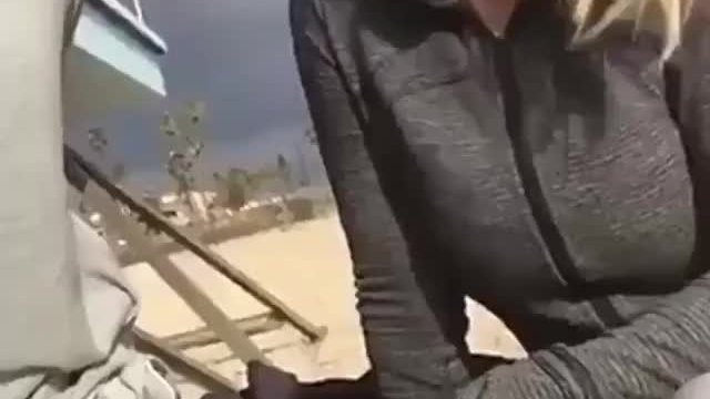 Giving him a sneaky blowjob on a beach